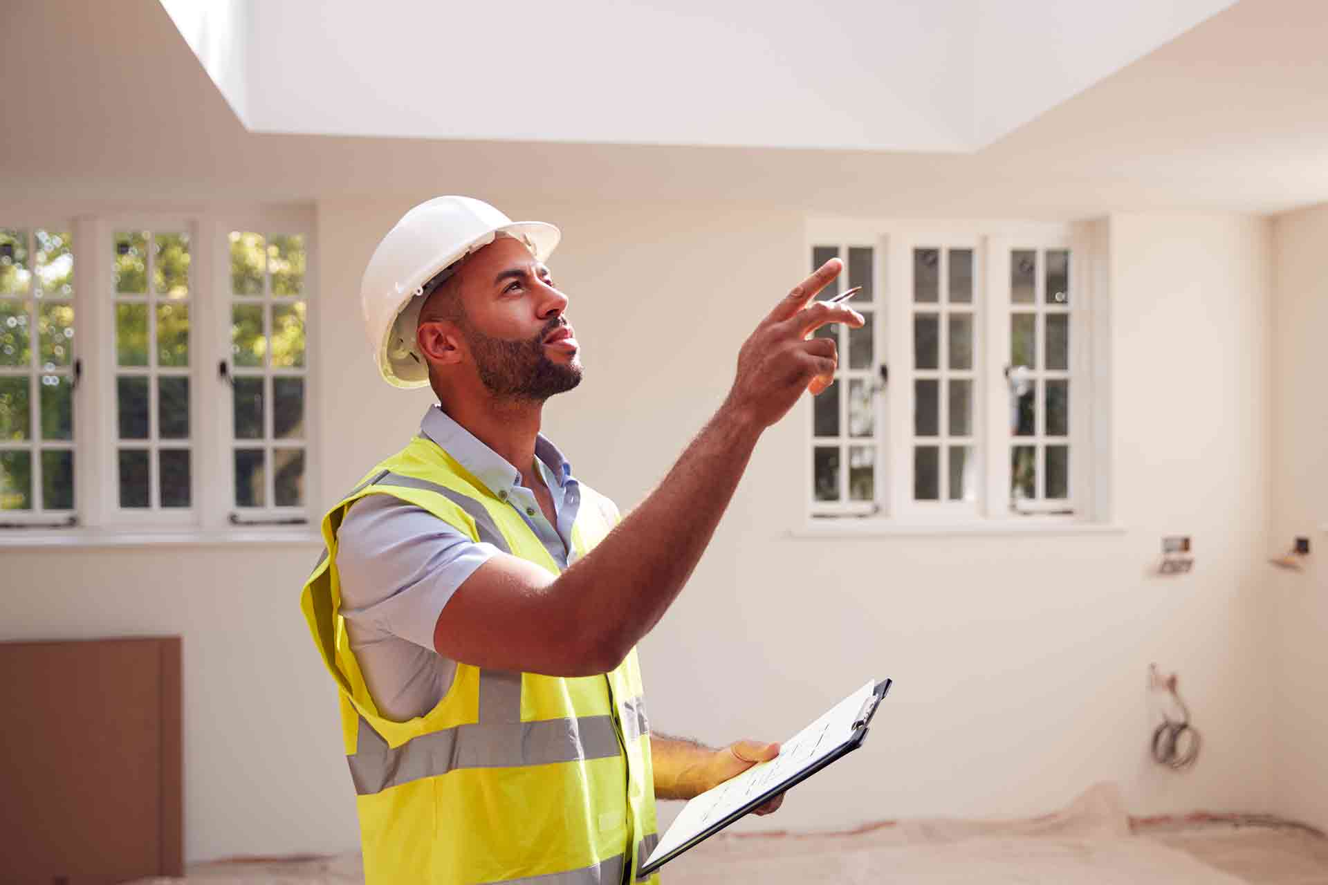 Third Party Wall Surveyors Liverpool reviewing plans between two parties during a dispute